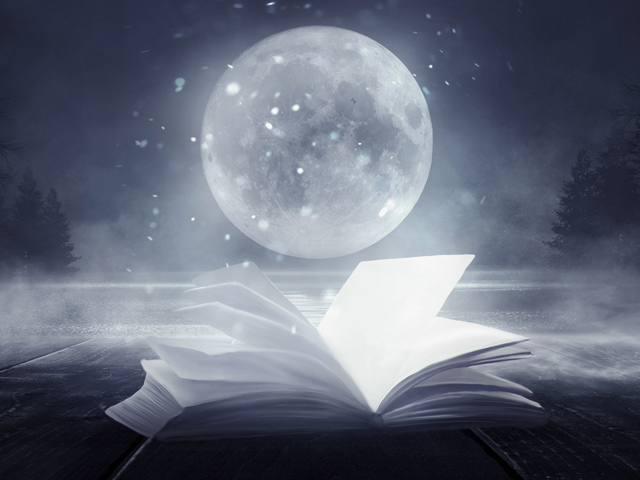 open book under full moon against night sky